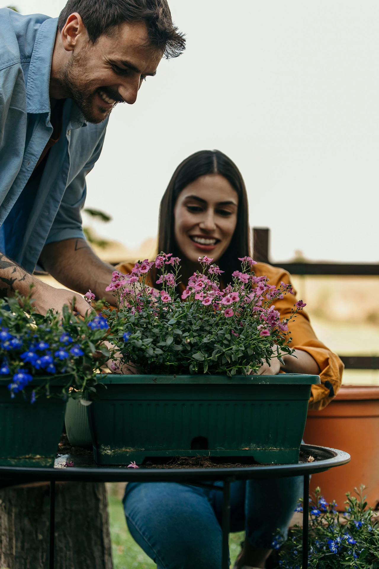 Vega Lend couple in the garden with new pots of flowers